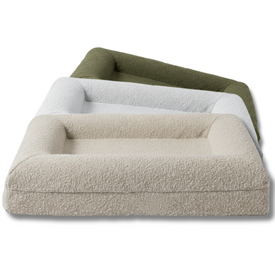 Three pet beds in beige, white, and green on a white background